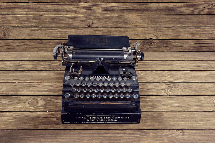 black typewriter on brown surface