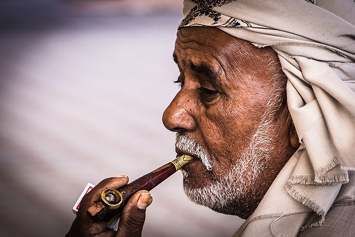 man with pipe and white bandana