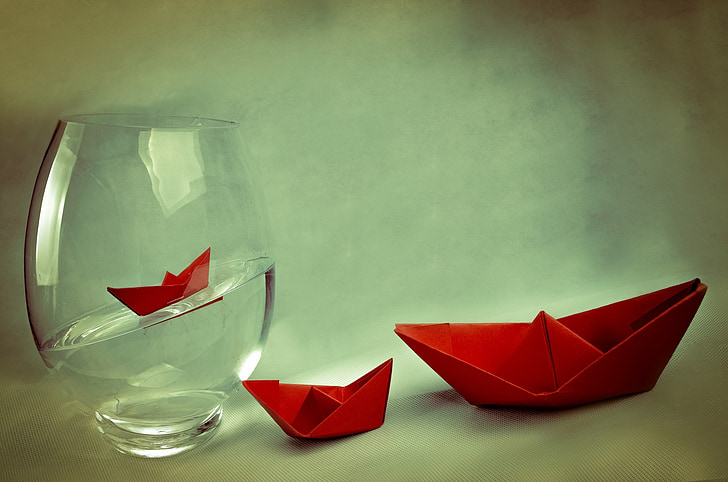 red paper boat and glass