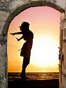 person standing beside door during sunset