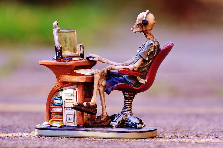 Royalty-Free photo: Skeleton sitting in front of desk ceramic figurine - PickPik