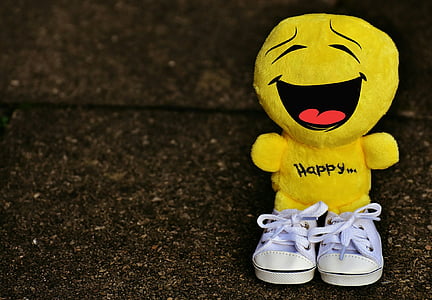 portrait photography of yellow emoji wearing pair of white shoes