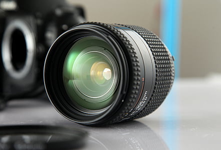 black telephoto lens on gray surface