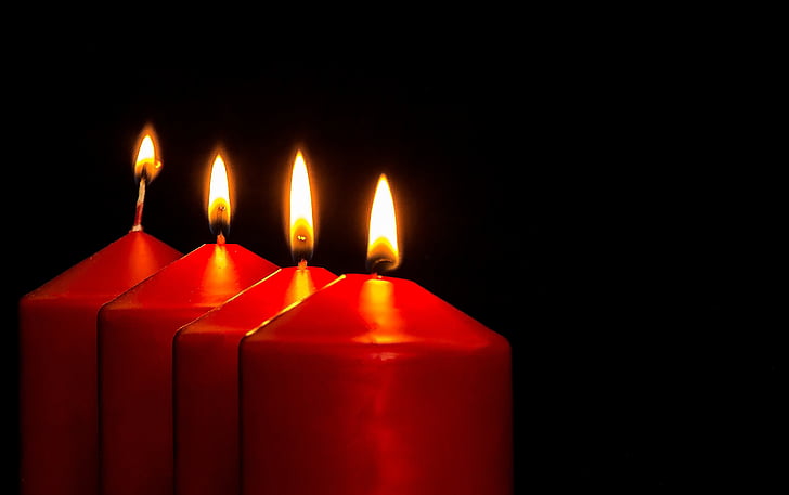 four red lighted pillar candles