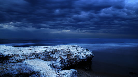 white cliff under cloudy sky