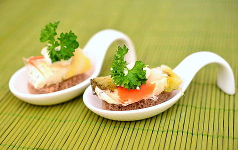 appetizer with leafy green on white ceramic spoon