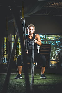 woman holding rope on gym