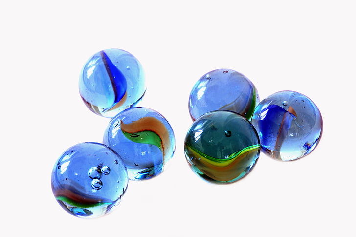 six blue marble toys on white background