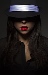 woman wearing black hat and red lipsticks