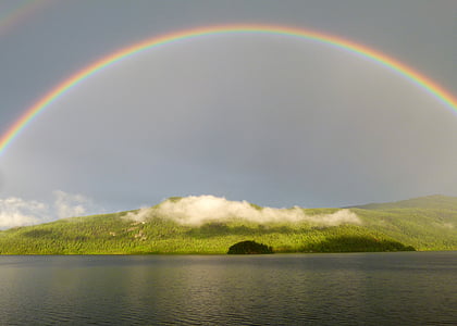 rainbow on top of green hills