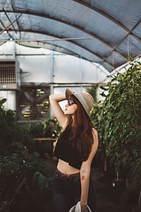 woman wearing crop top surrounded by plants