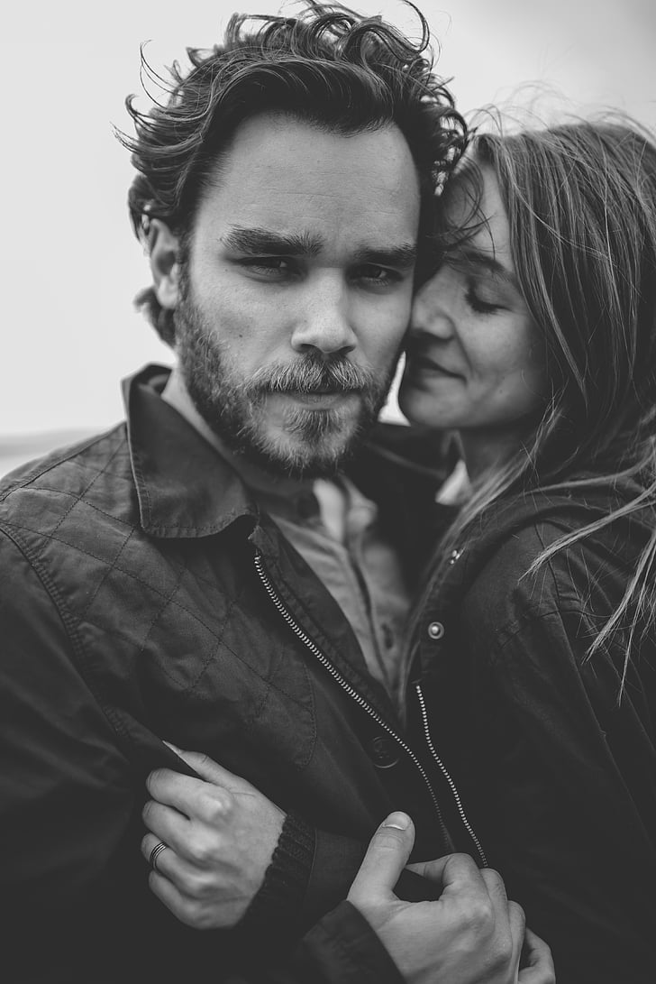 grayscale photography of woman embracing man
