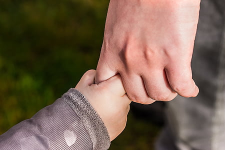 person holding child's hand