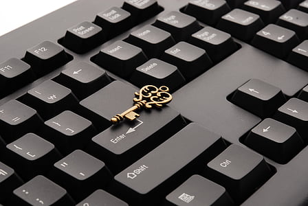 brass skeleton key on computer keyboard