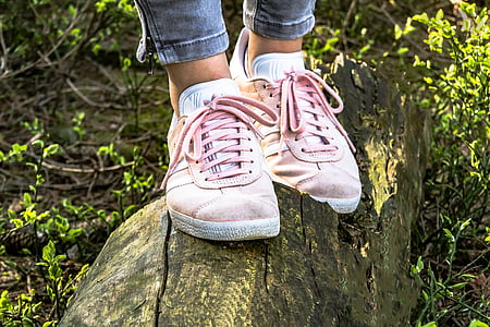 person wearing pair of pink low-top sneakers