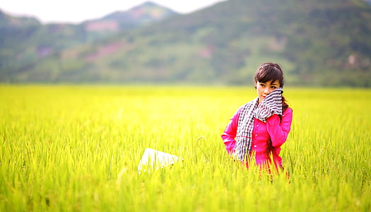 woman in pink coat on grass field