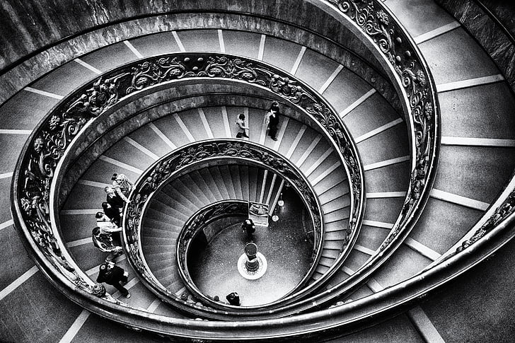 grayscale photography of spiral staircase