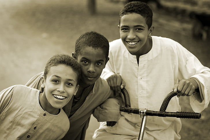 three boy with bicycle