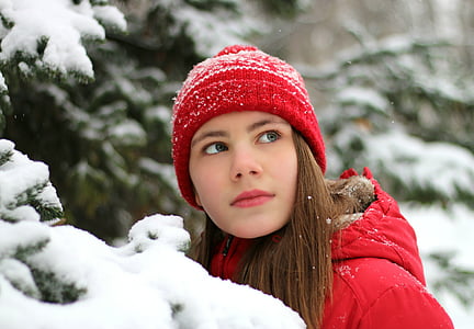 woman wearing red knit cap and red hooded jacket
