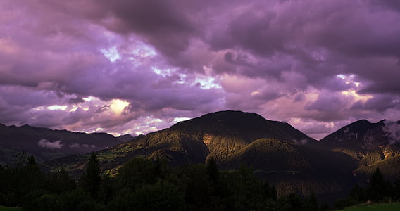 black mountains under purple clouds