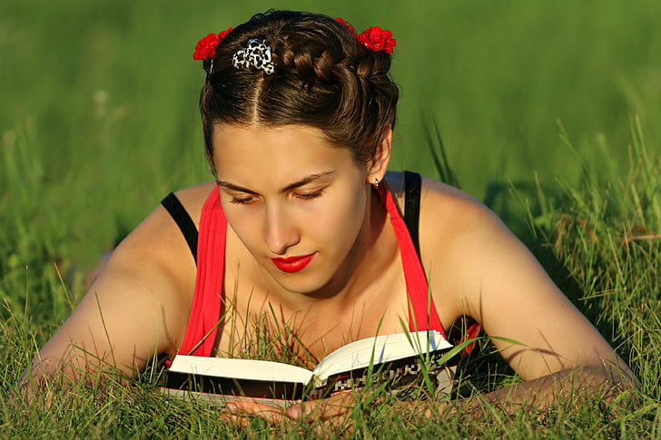 brown haired woman wearing red and white halter top on grass field