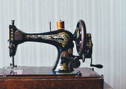 black treadle sewing machine with brown spool on top