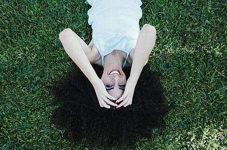 photograph of woman spreading hair on grass