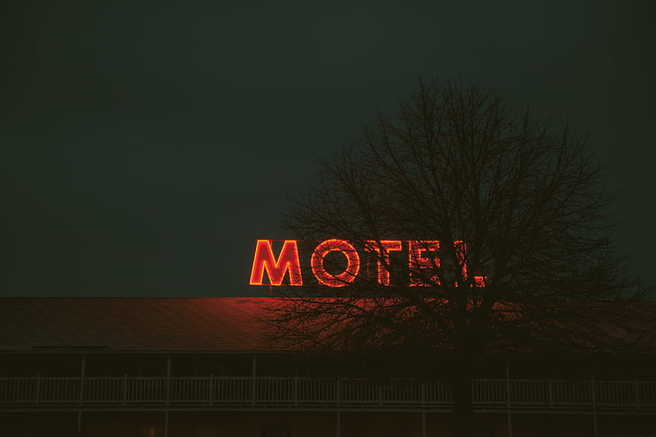 red neon light Motel signage turned ON
