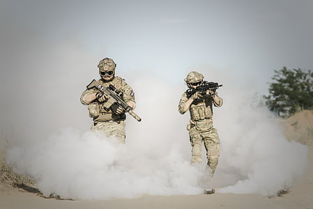 men wearing military uniform holding assault rifle during daytime