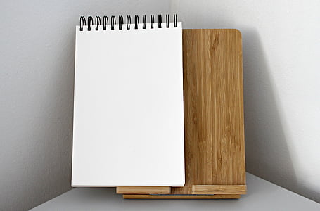 white sketch pad on brown wooden board