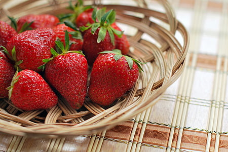 red strawberries in brown wicker basket