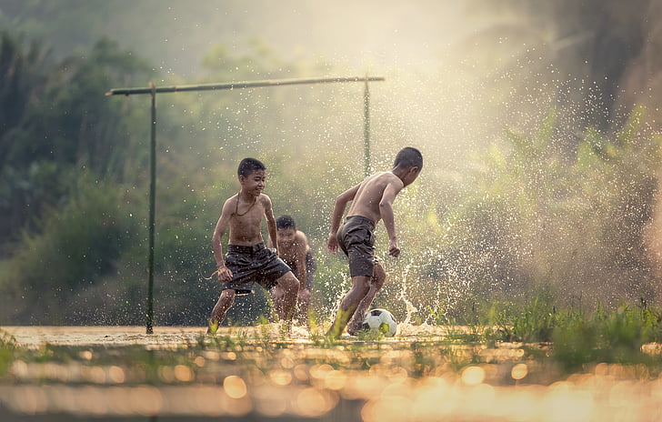 tilt-shift photography of children playing with water