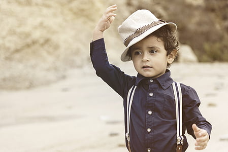 boy in black dress shirt with suspender and hat