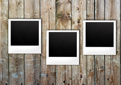 three white wooden frames on wall