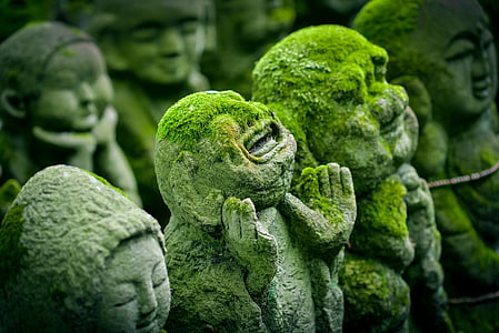 human concrete statue with moss