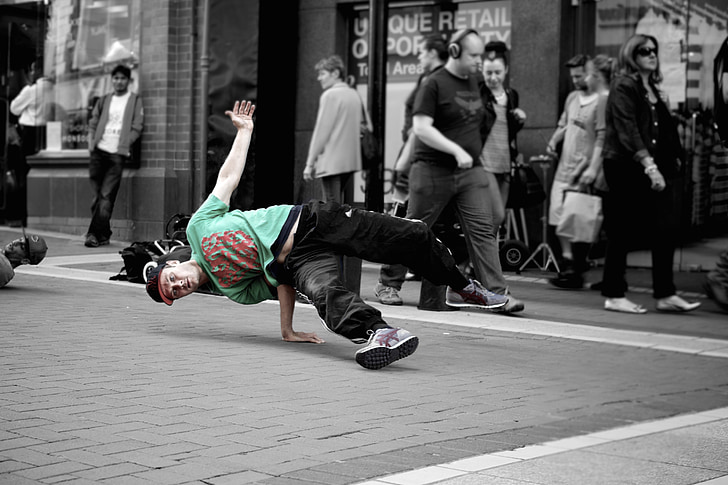 selective color photo of man in green and red t-shirt