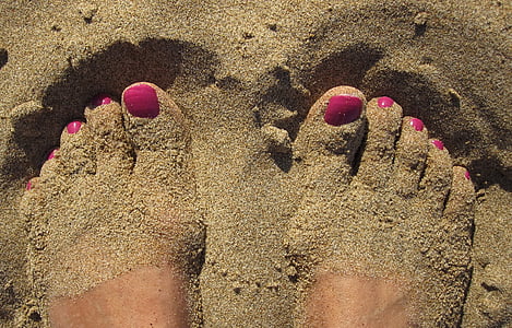 feet covered with brown sand