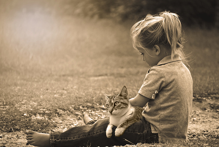 grayscale photo of girl and cat