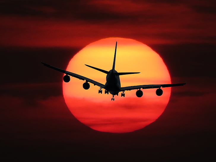silhouette photo of air liner during golden hour