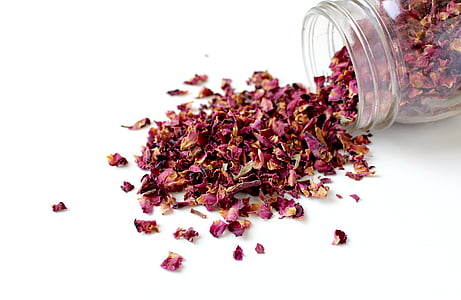 red petals in clear glass jar