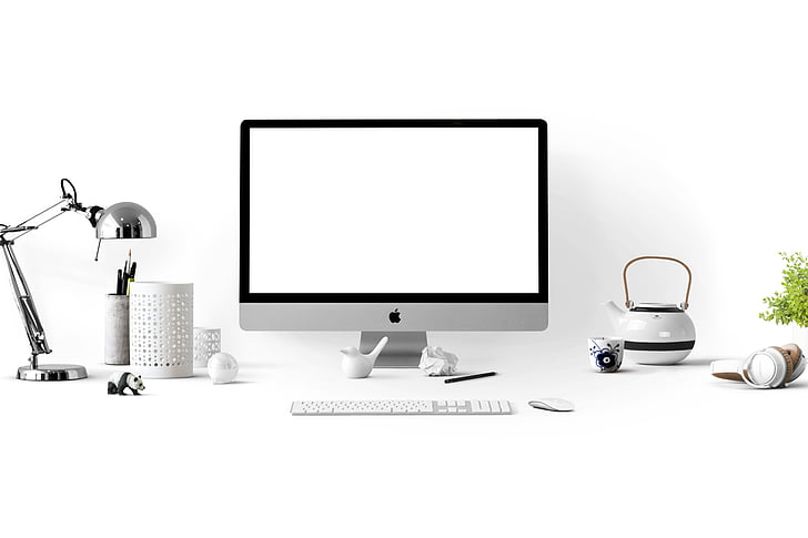 silver iMac beside wireless keyboard and mouse