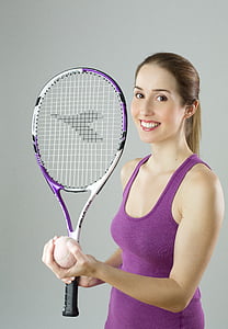 woman in purple tank top holding tennis racket and ball