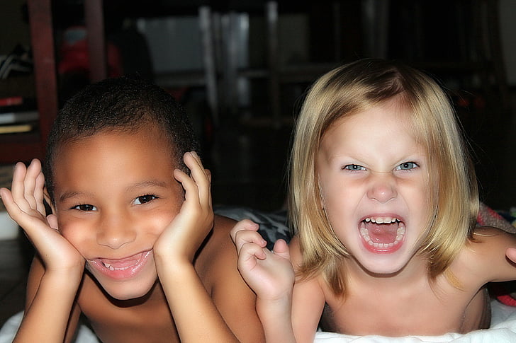 photography of little girl with blonde hair and little boy with black hair