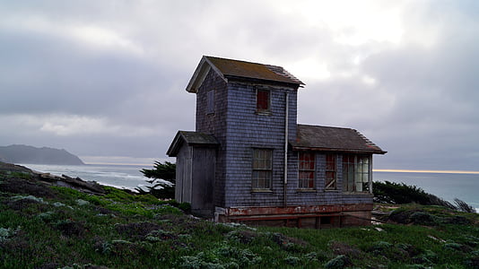 gray house near sea at daytime