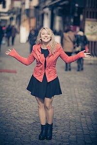 shallow focus photography of woman in red double-breasted pea coat