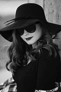 grayscale photo of woman wearing black sunhat