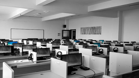 white office desks with black headsets