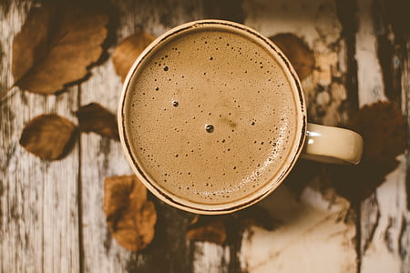 photography of latte coffee in mug
