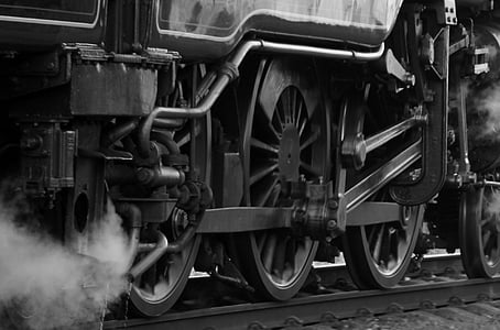 grayscale photography of train wheels