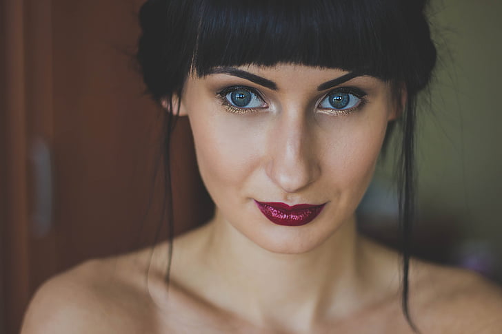woman with maroon lipsticks and false mascara